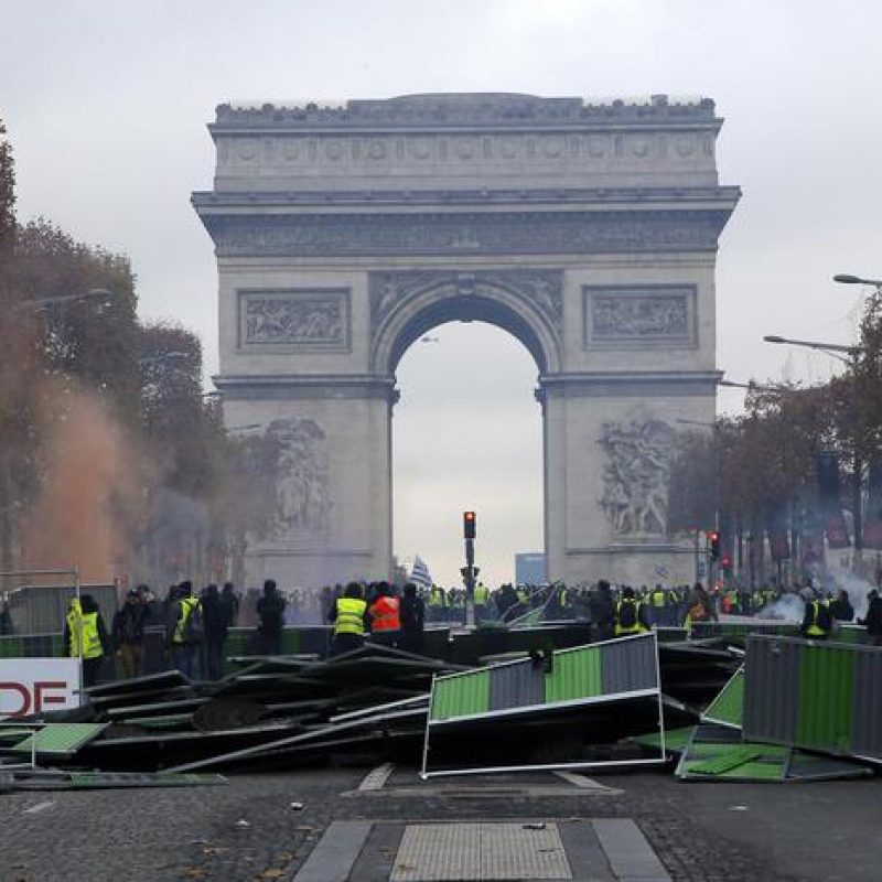 A barricade is set up on the Champs-Elysees avenue, with the Arc de Triomphe in background, during a demonstration against the rising of the fuel taxes, Saturday, Nov. 24, 2018 in Paris. French police fired tear gas and water cannons to disperse demonstrators in Paris Saturday, as thousands gathered in the capital and staged road blockades across the nation to vent anger against rising fuel taxes and Emmanuel Macron's presidency. (ANSA/AP Photo/Michel Euler) [CopyrightNotice: Copyright 2018 The Associated Press. All rights reserved.]