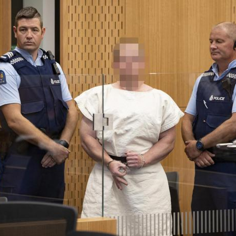 epa07441050 Brenton Tarrant (Pixelated) makes a sign to the camera during his appearance, on a charge of murder for Christchurch mosque massacre in the District Court, Christchurch, New Zealand, 16 March 2019. At least 49 people were killed by a gunman, believed to be Brenton Harrison Tarrant, and 20 more injured and in critical condition during the terrorist attacks against two mosques in New Zealand during Friday prayers on 15 March. EPA/Martin Hunter / POOL NEW ZEALAND OUT