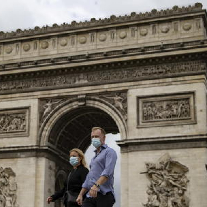epa08631689 A couple wearing protective face masks walk on the Champs Elysees near the Arc de Triomphe, in Paris, France, 28 August 2020. As of 8am on 28 August, protective face masks are mandatory across the city of Paris, a measure annouced by French Prime Minister Jean Castex on 27 August to fight the rising spread of coronavirus SARS-CoV-2 which causes the Covid-19 disease. Cases in France have surged in recent weeks, with over 6000 new cases recorded in a 24 hour period. EPA/IAN LANGSDON