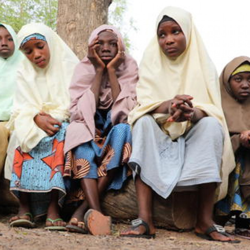 epa09039160 Students, who escaped from gunmen, wait outside the school premises for their parents after gunmen abducted more than 300 students at the Jangebe Government Girls Secondary School, Zamfara State, Nigeria 26 February 2021. According to regional police over 300 girl students were abducted by gunmen in Jangede marking this as the third school attack in Nigeria in less than three months. EPA/STR