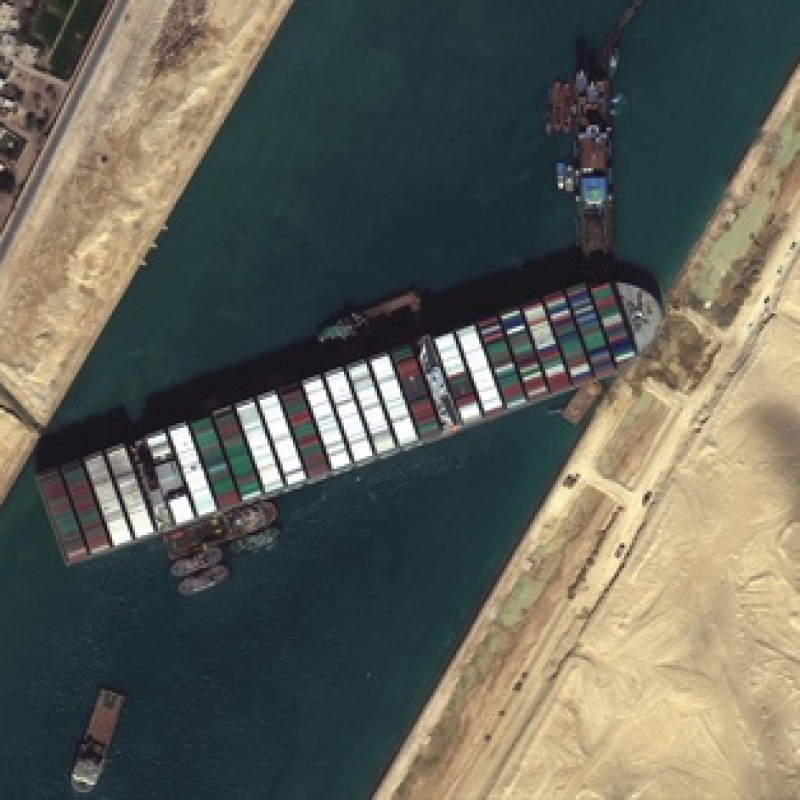 epa09101181 A handout satellite image made available by MAXAR Technologies shows multiple tug boats positioned alongside the 'Ever Given' and dredging operations in progress, in the Suez Canal, Egypt, 27 March 2021. The large container ship Ever Given ran aground in the Suez Canal on 23 March, blocking passage of other ships and causing a traffic jam for cargo vessels. The head of the Suez Canal Authority announced on 25 March that 'the navigation through the Suez Canal is temporarily suspended' until the floatation of the Ever Given is completed. Its floatation is being carried out by eight large tugboats that are towing and pushing the grounding vessel. EPA/MAXAR TECHNOLOGIES HANDOUT -- MANDATORY CREDIT: SATELLITE IMAGE 2020 MAXAR TECHNOLOGIES -- the watermark may not be removed/cropped -- HANDOUT EDITORIAL USE ONLY/NO SALES HANDOUT EDITORIAL USE ONLY/NO SALES