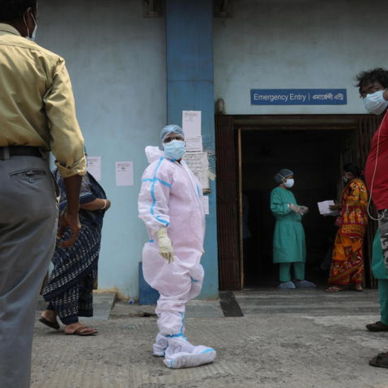 epa09170939 Health workers attend to the relatives of admitted COVID-19 patients at a COVID-19 hospital in Kolkata, India, 01 May 2021. The West-Bengal state government imposed a one-month partial lockdown to curb the spread of COVID-19. The country has reported a record number of 400,000 new COVID-19 cases in one day. EPA/PIYAL ADHIKARY