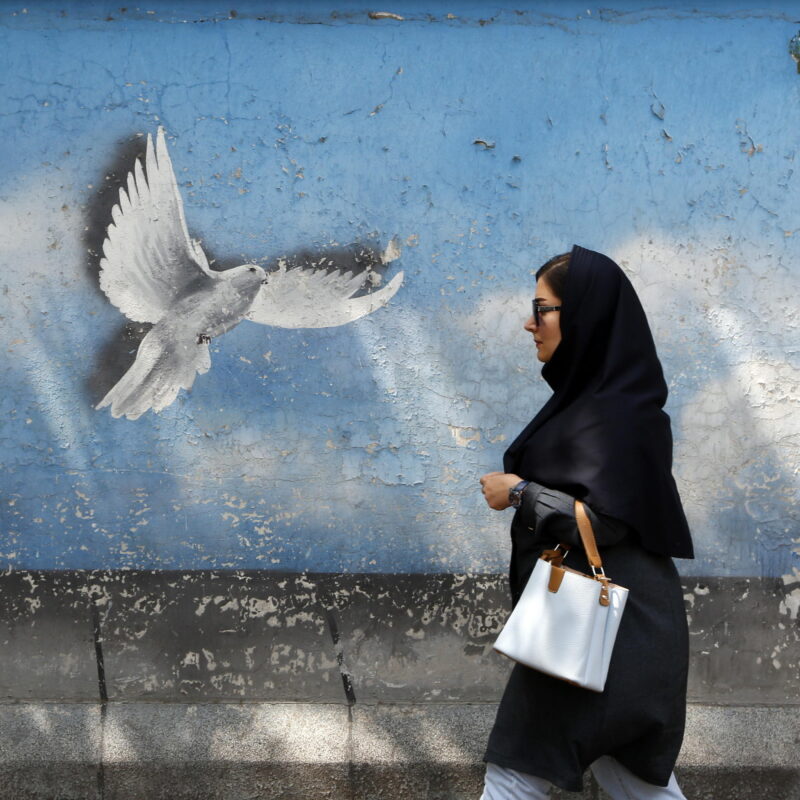 epaselect epa11300273 A woman walks past a wall painting of a peace bird in Tehran, Iran, 25 April 2024. Tension between Iran and Israel continues since Iran's Islamic Revolutionary Guards Corps (IRGC) launched drones and missiles towards Israel on 13 April 2024, following an airstrike on the Iranian embassy in Syria, which Iran claimed was conducted by Israel. Iranian state media reported that three aerial objects were destroyed by air defense systems over the central city of Isfahan in the early morning of 19 April 2024. EPA/ABEDIN TAHERKENAREH