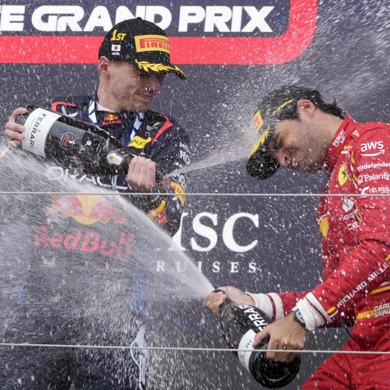 epa11263725 First place Red Bull Racing driver Max Verstappen (L) of the Netherlands and third place Scuderia Ferrari driver Carlos Sainz Jr. of Spain celebrate on the podium with champagne after the Formula One Japanese Grand Prix at the Suzuka International Racing Course in Suzuka, Japan, 07 April 2024. EPA/FRANCK ROBICHON