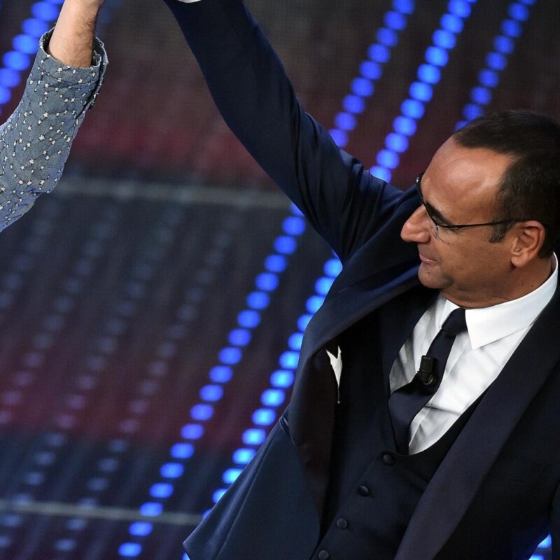 Italian singer Francesco Gabbani (L) with Italian host Carlo Conti (R), reacts on the stage of the Ariston Theatre after winning in the category 'young singers' with the song 'Amen' in Sanremo, Italy, 12 February 2016. The 66th Festival della Canzone Italiana runs from 09 to 13 February. ANSA/ETTORE FERRARI