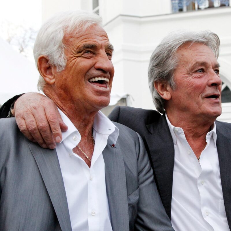 (FILES) French actors Jean-Paul Belmondo (L) and Alain Delon (R) attend the inauguration of Paul Belmondo museum dedicated to the work of Jean-Paul Belmondo's father, in Boulogne-Billancourt, outside Paris, in Boulogne-Billancourt on September 14, 2010. French film legend Alain Delon has died at the age of 88, his three children told AFP in a statement on August 18, 2024, following a battle with ill health. (Photo by PATRICK KOVARIK / AFP)