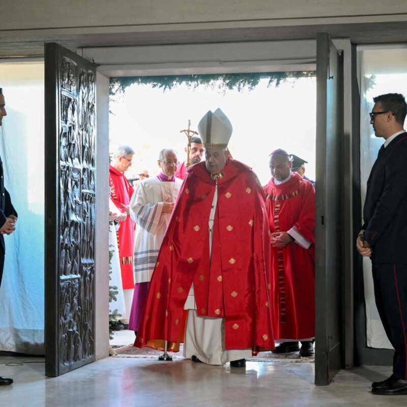 This photo taken and handout on December 26, 2024 by The Vatican Media shows Pope Francis opening a Holy Door at Rebibbia Penitentiary on Saint Stephen day in Rome as part of the Catholic Jubilee Year. (Photo by Handout / VATICAN MEDIA / AFP) / RESTRICTED TO EDITORIAL USE - MANDATORY CREDIT "AFP PHOTO / VATICAN MEDIA" - NO MARKETING - NO ADVERTISING CAMPAIGNS - DISTRIBUTED AS A SERVICE TO CLIENTS