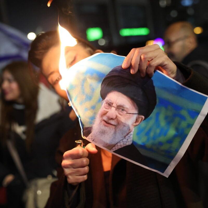 epaselect epa12649253 A member of the Israeli Iranian community burns a picture of Iran's Supreme Leader Ali Khamenei during a protest supporting the people of Iran, in the city of Holon, Israel, 14 January 2026. Economic crisis and political repression have triggered nationwide anti-government protests across Iran since late December 2025, despite a heavy crackdown. Protests around the world are taking place against the Iranian regime for the killing of protesters in the country. EPA/ABIR SULTAN